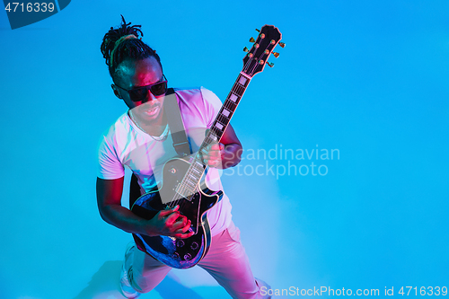 Image of Young african-american jazz musician playing the guitar