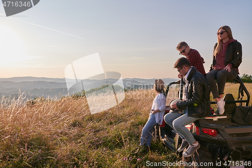 Image of group young happy people enjoying beautiful sunny day while driving a off road buggy car