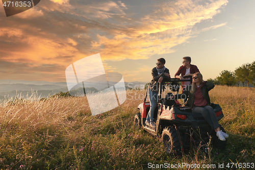 Image of group young happy people enjoying beautiful sunny day while driving a off road buggy car