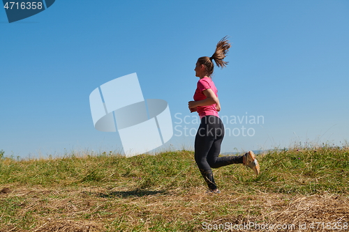 Image of woman enjoying in a healthy lifestyle while jogging