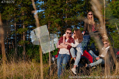 Image of group young happy people enjoying beautiful sunny day while driving a off road buggy car