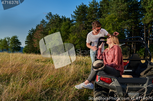 Image of couple enjoying beautiful sunny day while driving a off road buggy