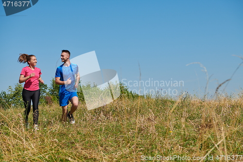 Image of couple jogging in a healthy lifestyle on a fresh mountain air