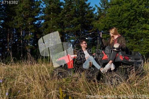 Image of couple enjoying beautiful sunny day while driving a off road buggy