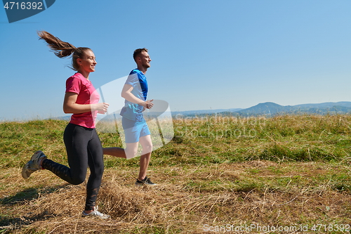 Image of couple jogging in a healthy lifestyle on a fresh mountain air