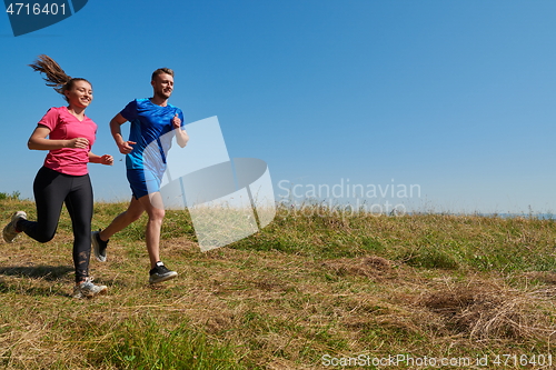 Image of couple jogging in a healthy lifestyle on a fresh mountain air