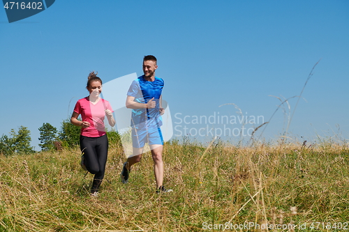 Image of couple jogging in a healthy lifestyle on a fresh mountain air