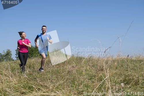 Image of couple jogging in a healthy lifestyle on a fresh mountain air