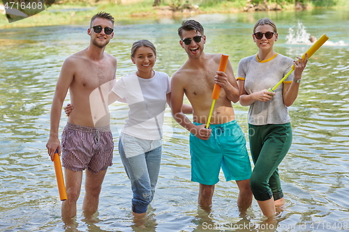 Image of group of happy friends having fun on river