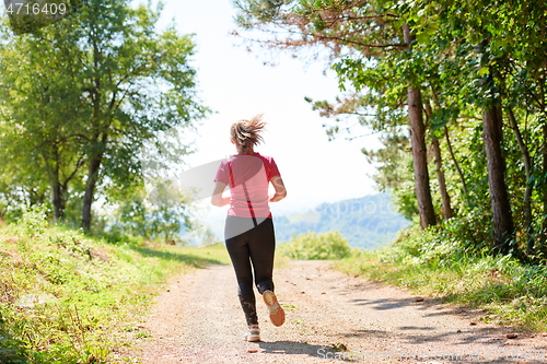 Image of woman enjoying in a healthy lifestyle while jogging