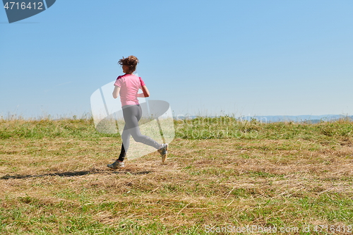 Image of woman enjoying in a healthy lifestyle while jogging