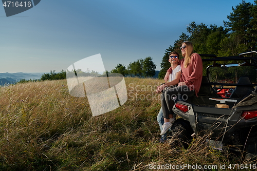 Image of couple enjoying beautiful sunny day while driving a off road buggy