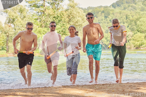 Image of group of happy friends having fun on river