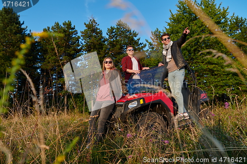 Image of group young happy people enjoying beautiful sunny day while driving a off road buggy car