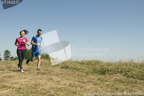 Image of couple jogging in a healthy lifestyle on a fresh mountain air