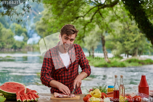 Image of man cooking tasty food for french dinner party