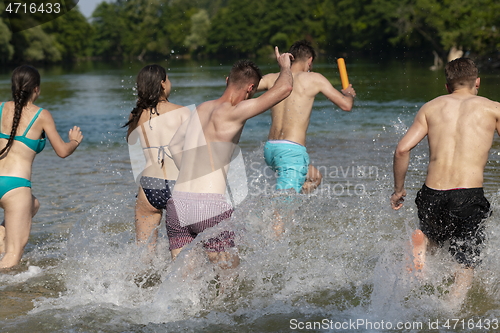 Image of group of happy friends having fun on river