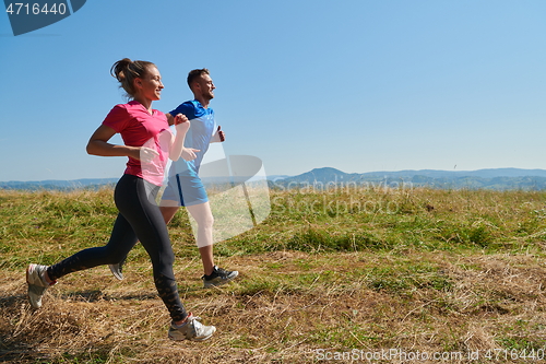 Image of couple jogging in a healthy lifestyle on a fresh mountain air