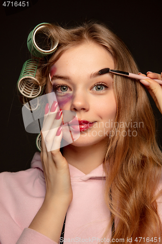 Image of Lie and another life in social media. Girl wearing make up on her face to hide bruises. Playing, pretending happy life.