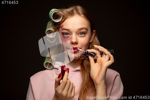 Image of Lie and another life in social media. Girl wearing make up on her face to hide bruises. Playing, pretending happy life.