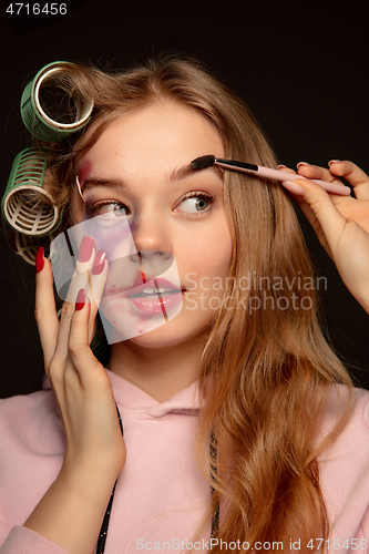 Image of Lie and another life in social media. Girl wearing make up on her face to hide bruises. Playing, pretending happy life.