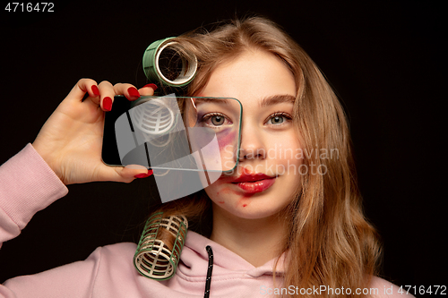 Image of Lie and another life in social media. Girl wearing make up on her face to hide bruises. Playing, pretending happy life.