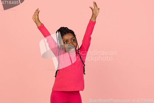 Image of Handsome african little girl portrait isolated on pink studio background with copyspace