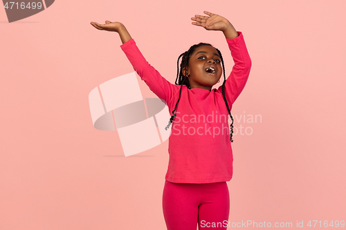 Image of Handsome african little girl portrait isolated on pink studio background with copyspace