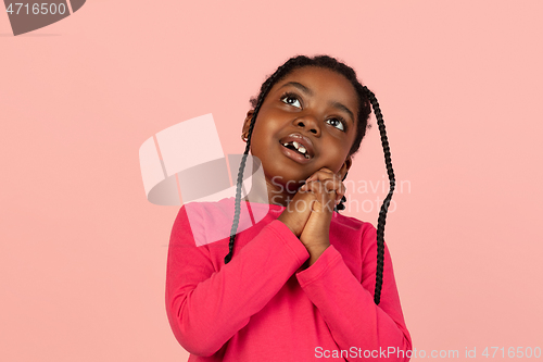 Image of Handsome african little girl portrait isolated on pink studio background with copyspace