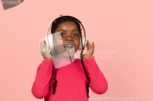 Image of Handsome african little girl portrait isolated on pink studio background with copyspace