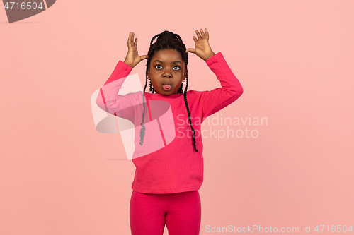 Image of Handsome african little girl portrait isolated on pink studio background with copyspace