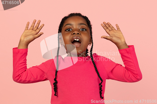 Image of Handsome african little girl portrait isolated on pink studio background with copyspace