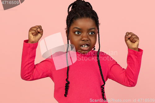 Image of Handsome african little girl portrait isolated on pink studio background with copyspace