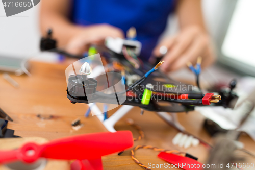 Image of Man installing the component on drone body