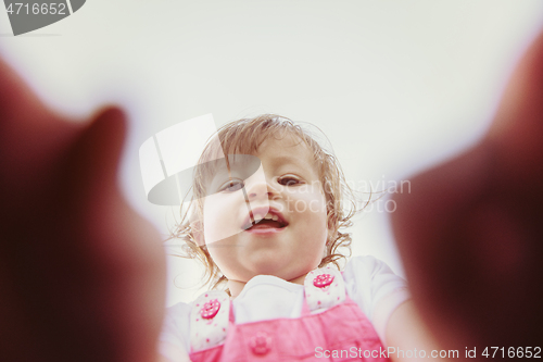 Image of little girl spending time at backyard