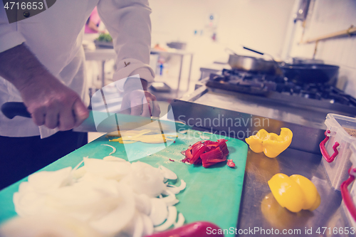 Image of Chef hands cutting fresh and delicious vegetables