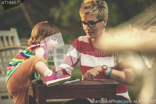 Image of mom and her little daughter using tablet computer