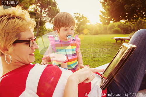 Image of mom and a little daughter relaxing in a hammock