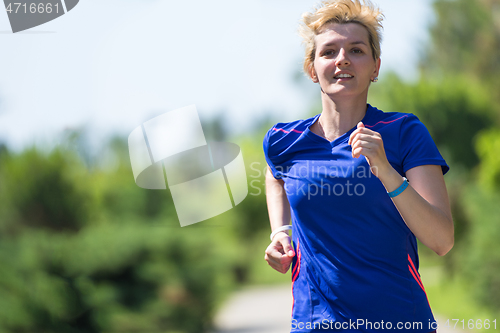 Image of young female runner training for marathon