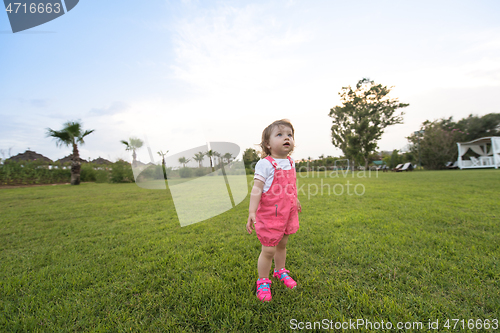 Image of little girl spending time at backyard