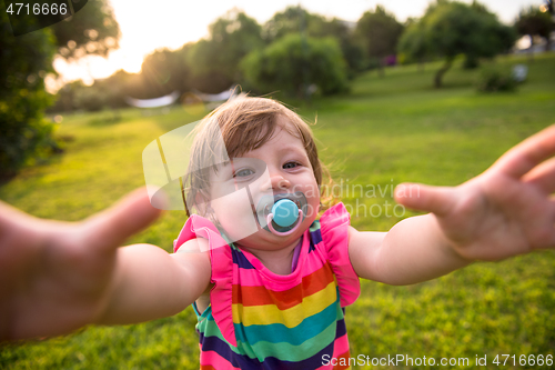 Image of little girl spending time at backyard