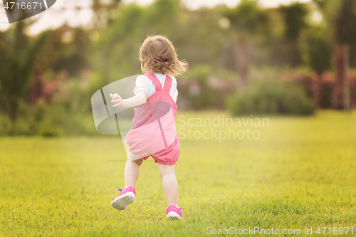 Image of little girl spending time at backyard