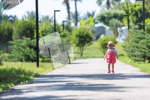 Image of little girl runing in the summer Park