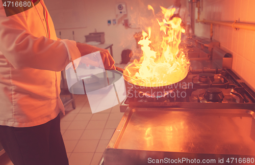 Image of Chef doing flambe on food