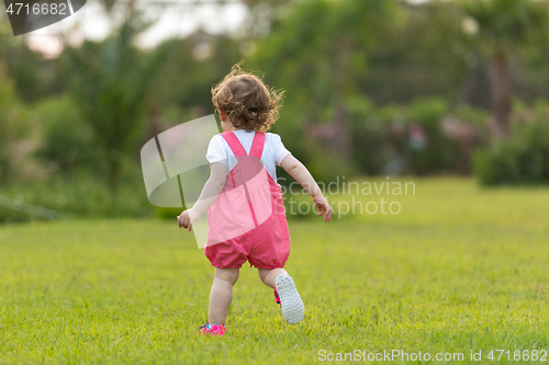 Image of little girl spending time at backyard