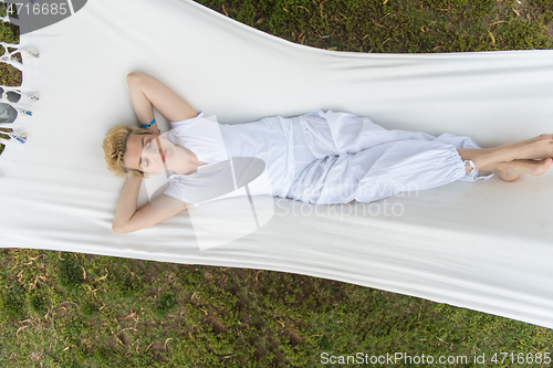 Image of young woman resting on hammock