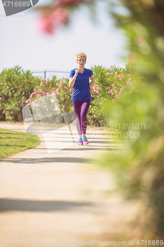 Image of young female runner training for marathon