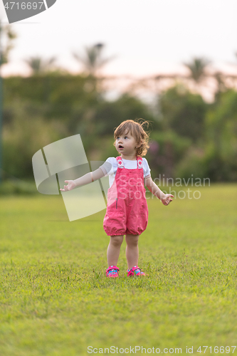 Image of little girl spending time at backyard