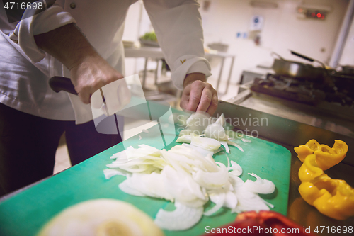 Image of Chef hands cutting fresh and delicious vegetables