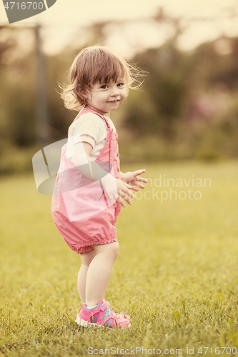 Image of little girl spending time at backyard